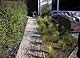 Gravel path to back yard near patio.